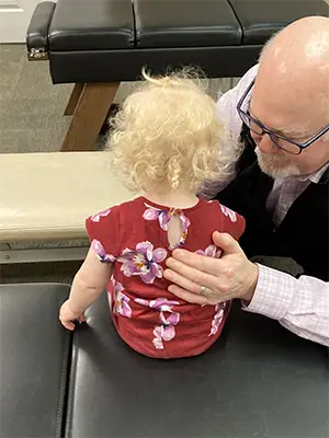 Chiropractor Marietta GA Paul Blumsack Adjussting Toddler